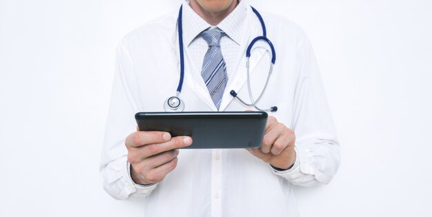 Male doctor holding a tablet in his hands.