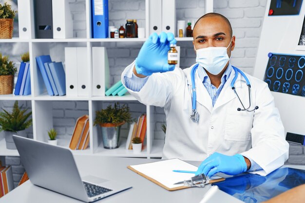 Male doctor holding vial of Sars-cov-2 vaccine in hand