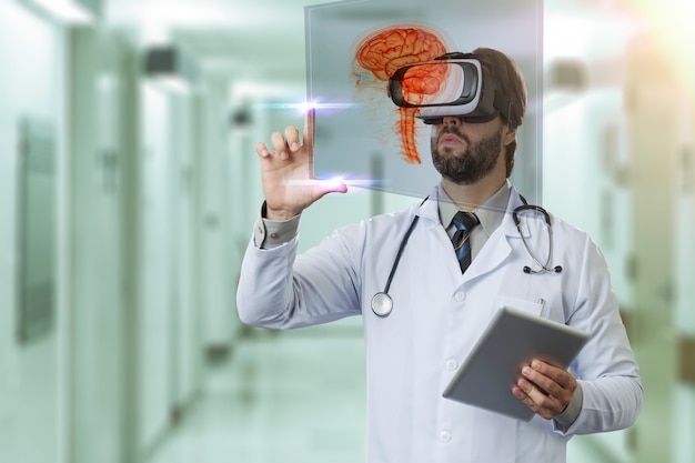 Male doctor at a hospital, using a Virtual Reality Glasses, looking at a virtual brain