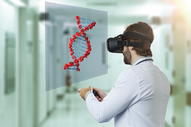 Male doctor at a hospital , using a Virtual Reality Glasses, looking at a virtual DNA