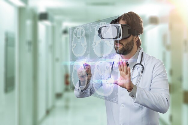 Male doctor at a hospital, using a Virtual Reality Glasses, looking at a virtual screen