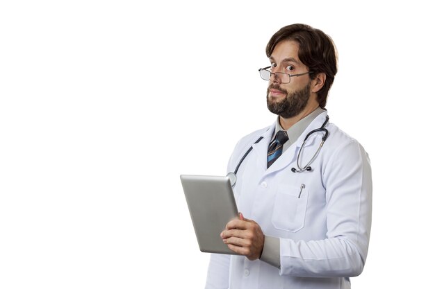 Male doctor looking at a tablet.