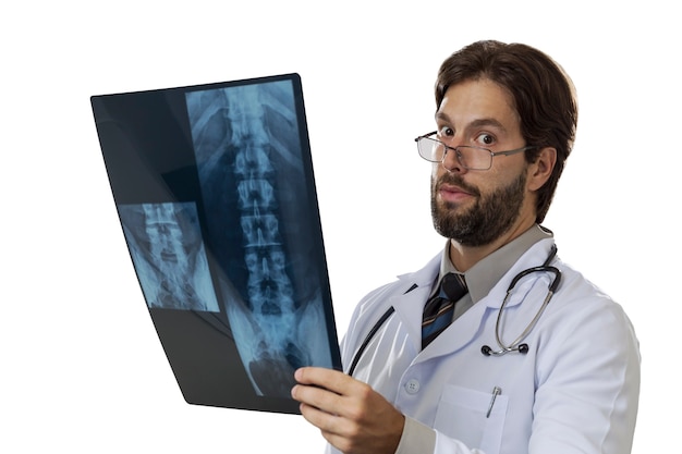 Male doctor looking at a x-Ray on a White space.