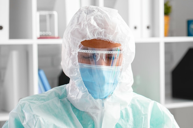 Male doctor in protective medical uniform in clinic