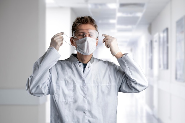 A male doctor put on protective uniform with mask and eye glasses in the hospital