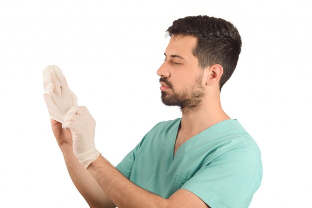 Male doctor putting gloves.