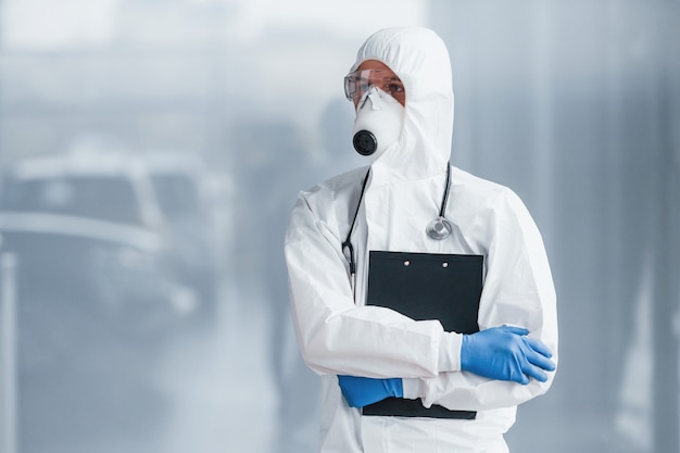 Male doctor scientist in lab coat, defensive eyewear and mask