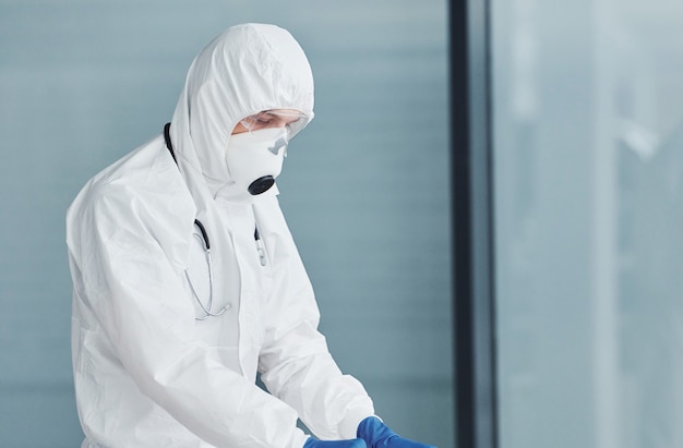 Male doctor scientist in lab coat, defensive eyewear and mask