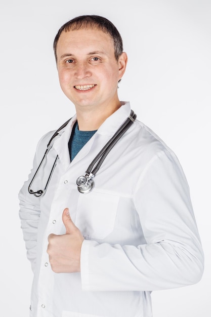 Male doctor show thumb up to you on white background