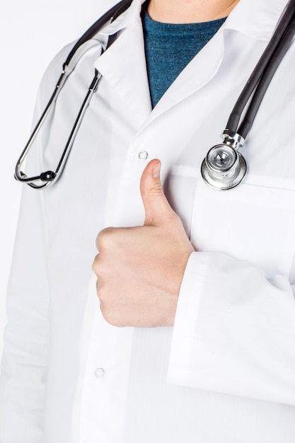 Male doctor show thumb up to you on white background