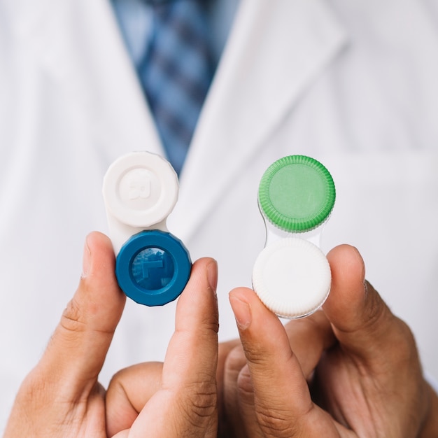 Male doctor showing two pair of contact lens