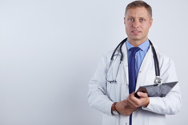 Male doctor standing with folder isolated on white background