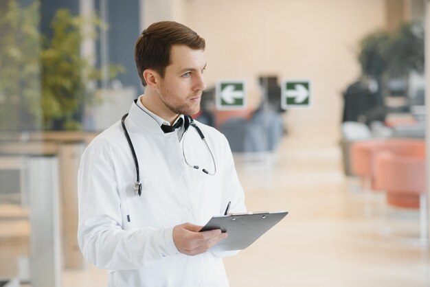 Male Doctor stands in the hall of the hospital