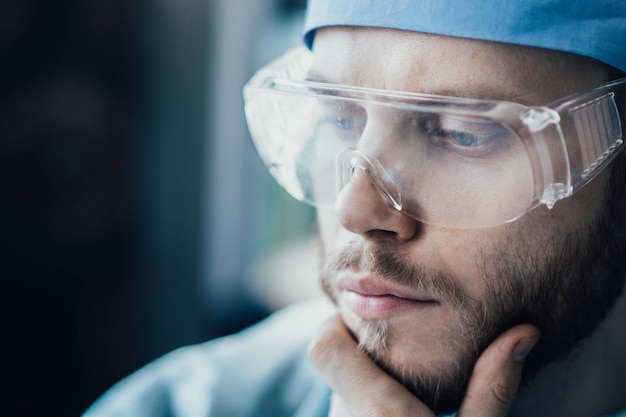 male doctor surgeon in uniform and glasses closeup