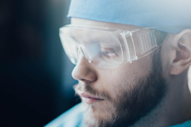 male doctor surgeon in uniform and glasses closeup