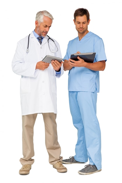 Male doctor and surgeon with digital tablets