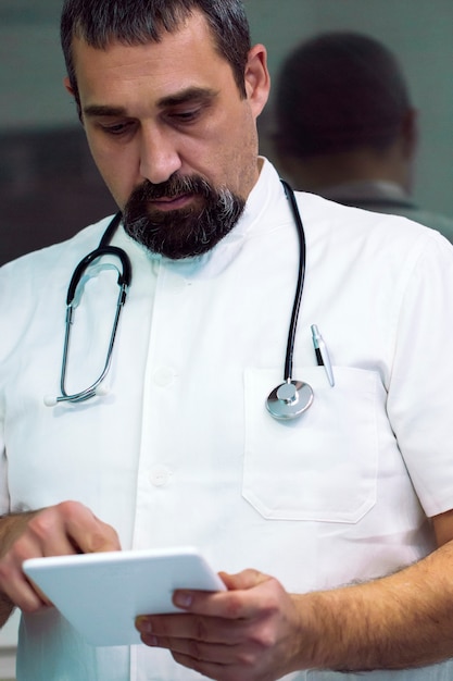 Male doctor using digital tablet