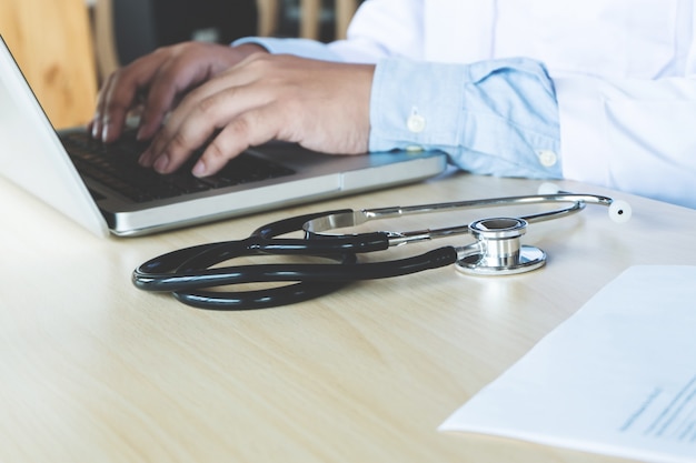 Male doctor using a laptop