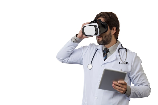 Male doctor using a Virtual Reality Glasses on a White space.