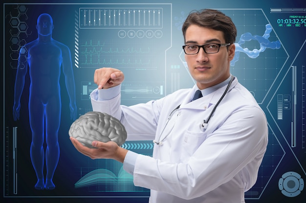 Male doctor with the brain in medical concept