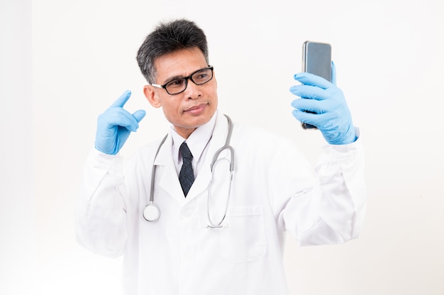 A male doctor with a phone video call with a patient to give advice.