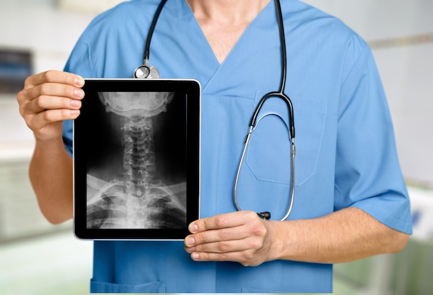 Male doctor with stethoscope with x-ray