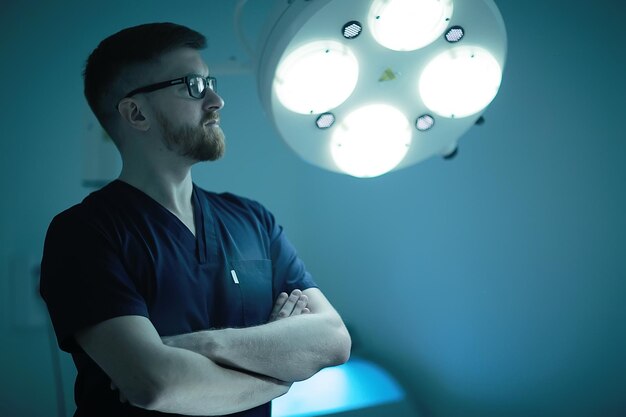 male doctor / young man in median uniform, strict doctor with glasses, medical clinic