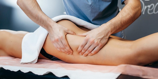 Мужские руки врачей делают антицеллюлитный массаж