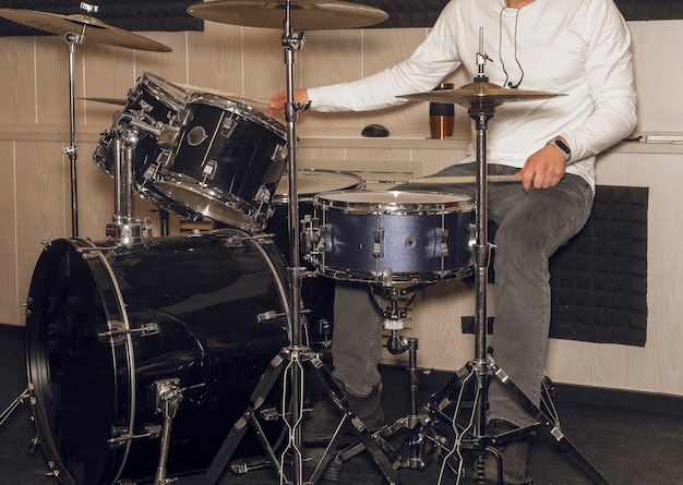 Male drum player hands holding cymbals with both hands and sticks drummer