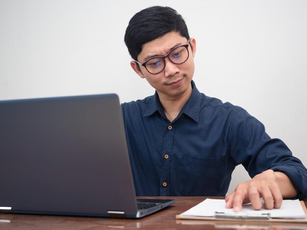 Male employee happy with working at his workplace table