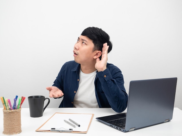 Male employee man sitting at office workplace gesture I can't hear want more louder