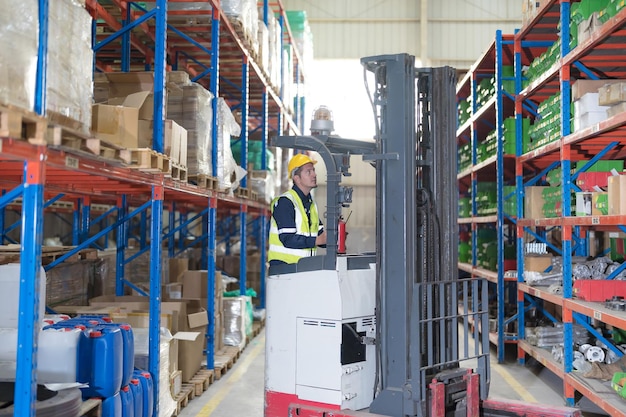 Male employee using a radio in the warehouse