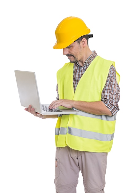 Male engineer in hardhat using laptop