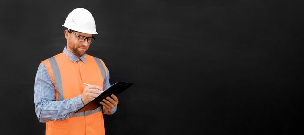 Male engineer in a white hard hats and orange west. handsome\
confident build worker isolated on blan