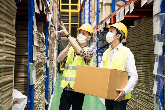 male engineer workers group wear mask work during covid in warehouse
