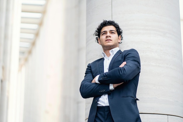 A male entrepreneur in a business suit near the office