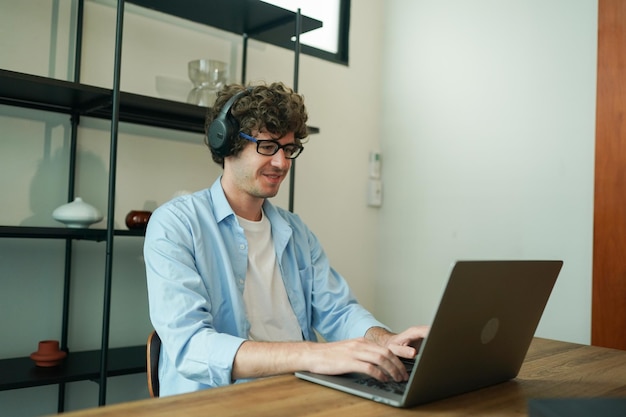 Male entrepreneur at home working on laptop and having leisure time