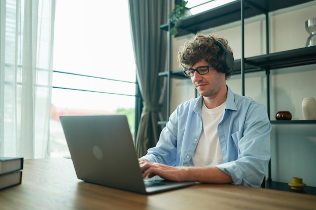 Male entrepreneur at home working on laptop and having leisure time