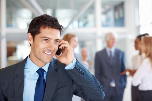 Male executive on call with team discussing Portrait of smart male executive on call with business team discussing in background