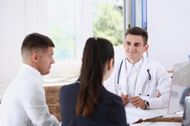 Male family doctor listen carefully young