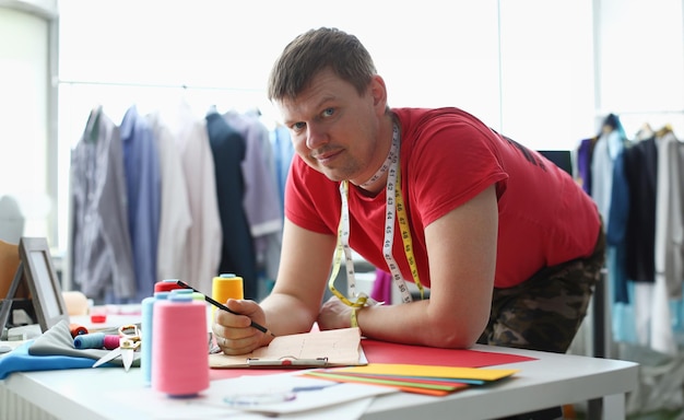 Male fashion designer working in studio in atelier