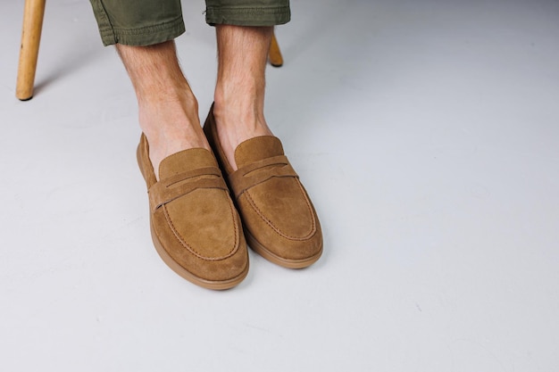 Male feet in brown suede casual shoes men's fashionable
shoes