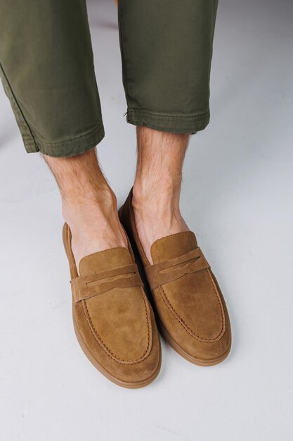 Male feet in brown suede casual shoes men\'s fashionable\
shoes