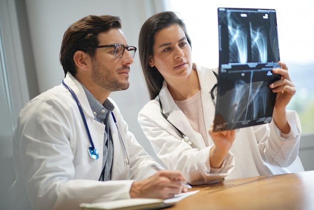  Male and female doctors going through patient's results                                              