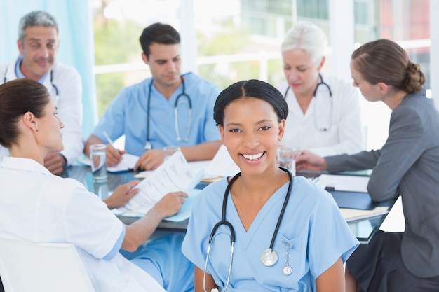 Male and female doctors working on reports