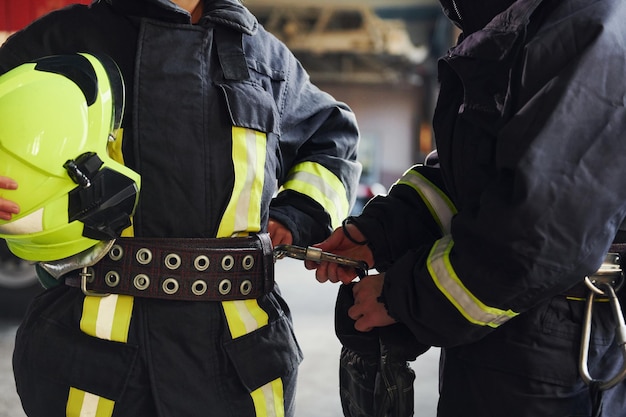 Male and female firefighters in protective uniform standing together