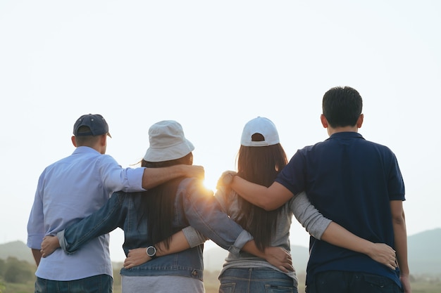 Photo male and female friends hugging each other looking at the sunrise friendship community concepts