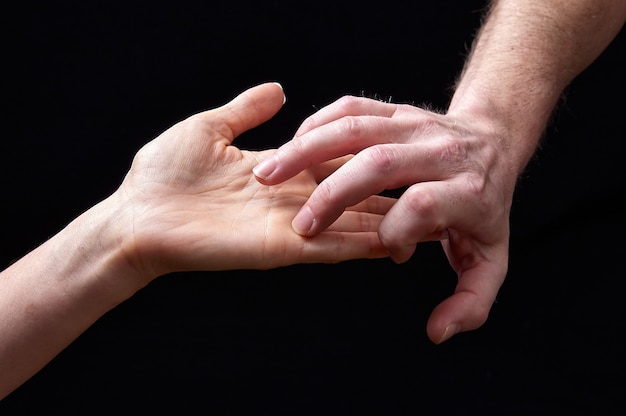 Male and female hands together showing emotions