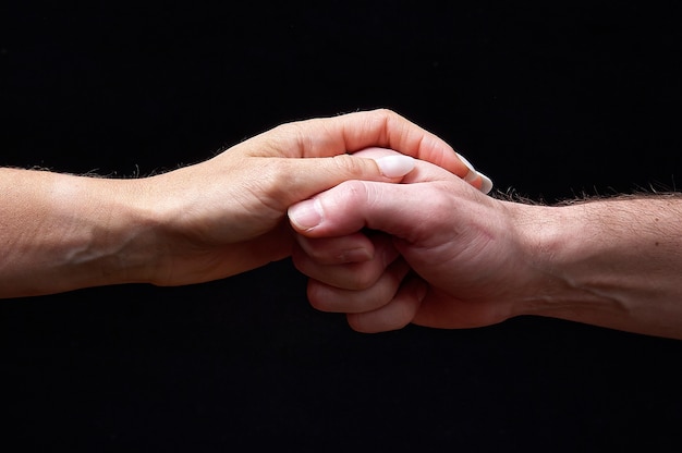 Male and female hands together showing emotions