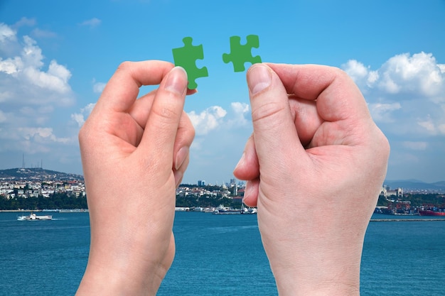 Male and female hands with little puzzle pieces